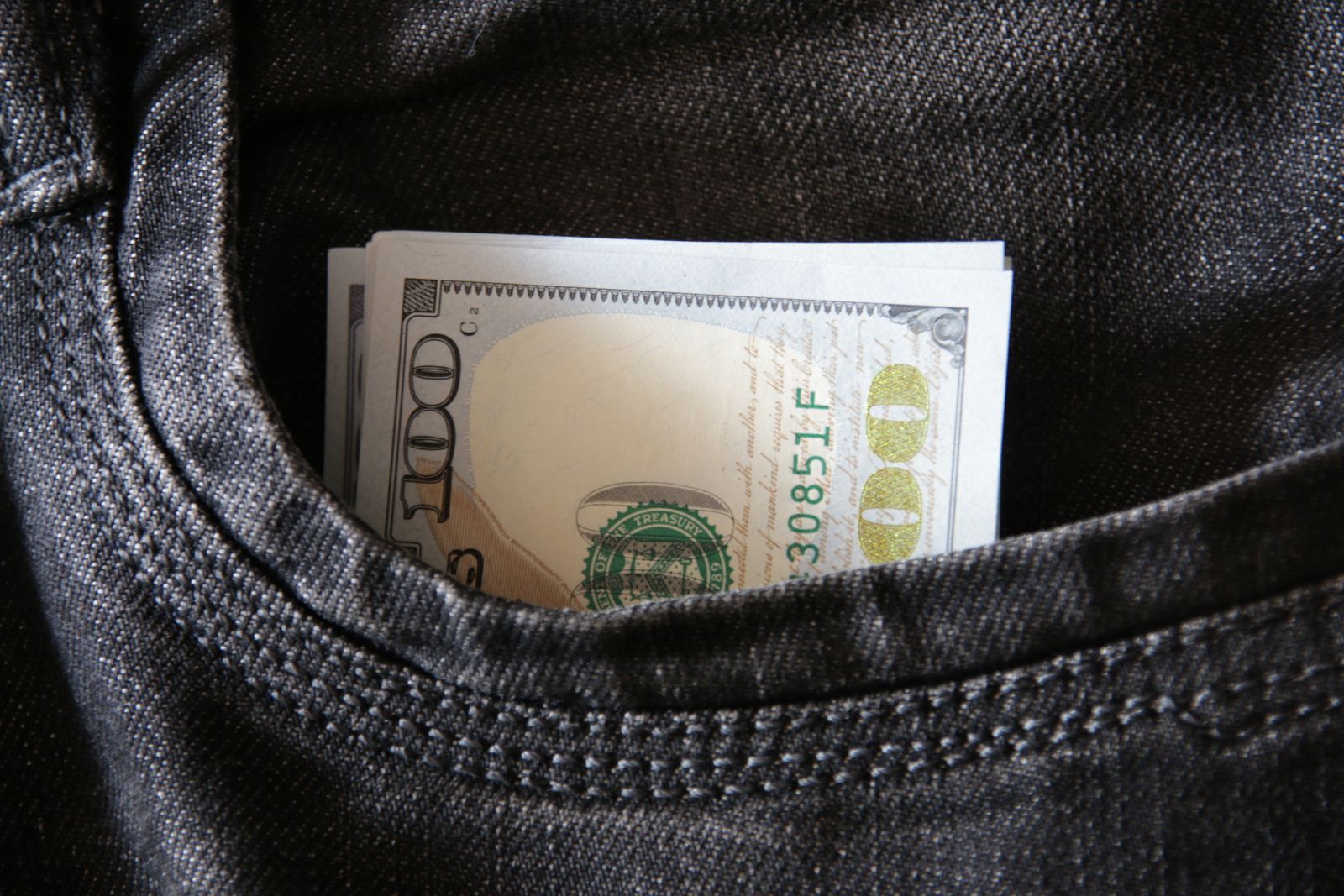 money in jeans pocket profit concept